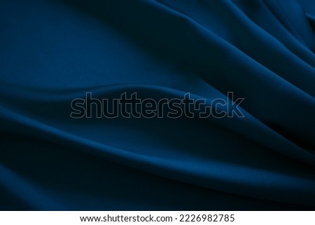 Black dark navy blue silk satin fabric cloth. Soft folds. Luxury elegant background for design. Wavy lines. Beautiful. Birthday, Christmas, New Year.