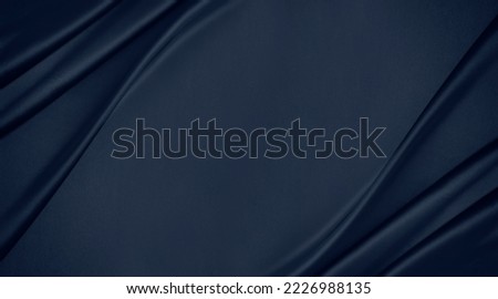Dark blue silk satin. Soft folds. Fabric. Navy blue luxury background. Space for design.Wavy lines. Banner. Flat lay, top view table. Beautiful. Elegant. Birthday, Christmas, Valentine's Day. Royalty-Free Stock Photo #2226988135