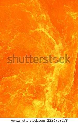 Defocus blurred transparent orange colored clear calm water surface texture with splashe and bubble. Trendy abstract nature background. Water waves in sunlight with copy space. Orange watercolor shine