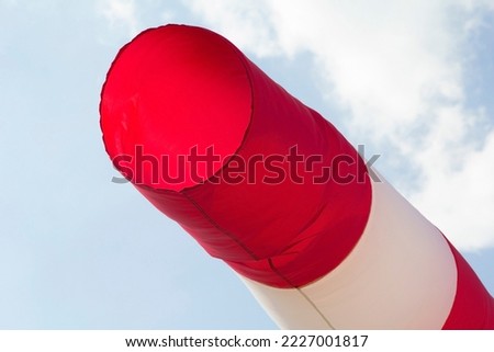 photo background bright rag cone windsock, in the blue clear sky at the airfield Sky Dive Dubai, Dubai, UAE