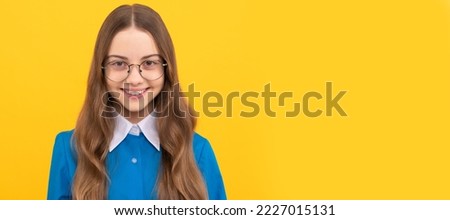 Because every kid is special. Happy kid in eyeglasses yellow background. Child face, horizontal poster, teenager girl isolated portrait, banner with copy space.