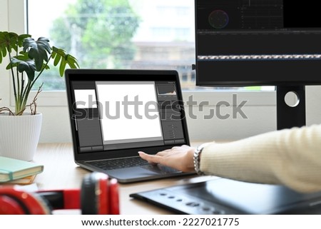 Cropped shot of female freelancer working editing video footage with professional computer at her workstation