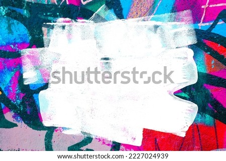 Closeup of colorful teal, blue and red urban wall texture with white white paint stroke. Modern pattern for design. Creative urban city background. Grunge messy street style background with copy space Royalty-Free Stock Photo #2227024939