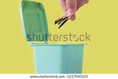 woman hand throwing in trash mini small garbage bin can broken smartphone white paper napkin towel,burnt matches or broken cigarette,lithium battery disposal.waste recycle,world anti tobacco day