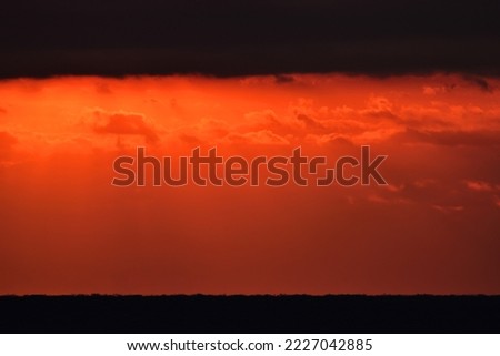 A fantastic sunset sky with sunlight shining into the sea surface.