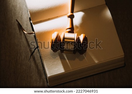 law books and scales of justice on desk in library of law firm. jurisprudence legal education concept.