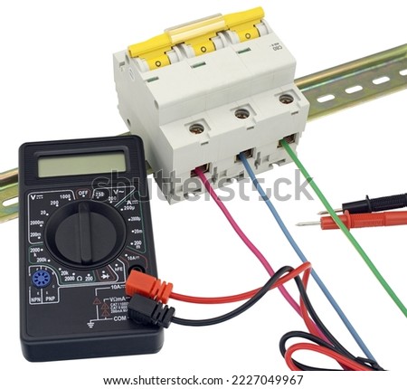 digital multimeter and circuit breakers with wires on white background