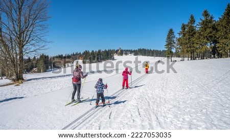 Young cross country skiers. Family trip on sunny winter day. Kralovka, Jizera Mountains, Czech Republic Royalty-Free Stock Photo #2227053035