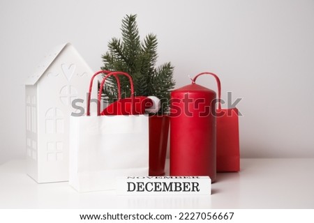 Winter greeting banner in red white and green, Candle,gift nag,santa hat,fir tree and toy house against white background