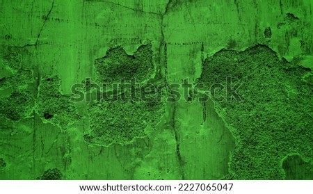 old wall background with greenery theme, peeling wall surface in the form of abstract art, green color background concept with cracked and broken old wall material