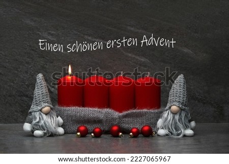 Advent photo series: Red Advent candles with funny Christmas elves. The German text eine schöne ersten Advent means a beautiful first Advent.