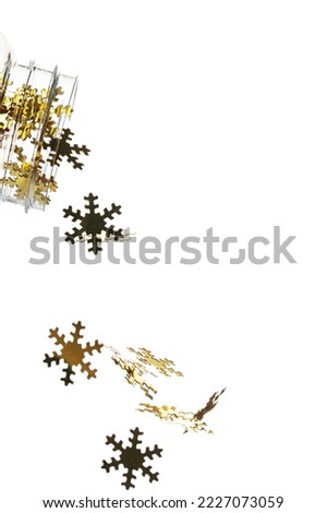 christmas decoration, golden confetti in the shape of snowflakes, isolated on a white background