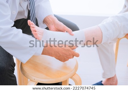 Medical image of a middle-aged woman being bandaged by a doctor