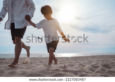 Asian family vacation father and son at the beach with family relationships running on sand playing together.Happy family travel on beach in holiday, Summer and freedom lifestyle travel on vacations.