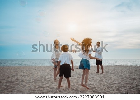 Happy asian family on the beach in holiday. of the family play blowing bubble.They are having fun playing enjoying on the beach. Summer Family and lifestyle.