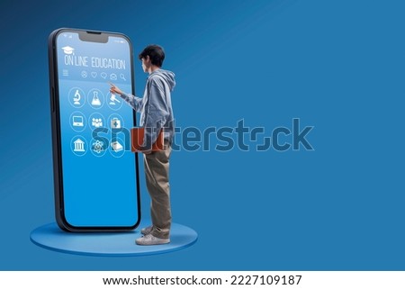 Smart student using a big smartphone with online education app interface, he is choosing a subject, e-learning concept Royalty-Free Stock Photo #2227109187