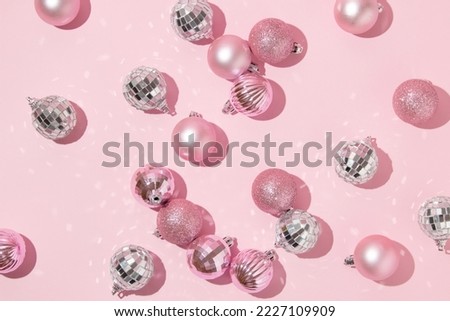 Christmas creative layout with pink Christmas baubles and disco ball decoration on pastel pink background. 80s or 90s retro fashion aesthetic concept. Minimal New Year or Christmas celebration idea. Royalty-Free Stock Photo #2227109909