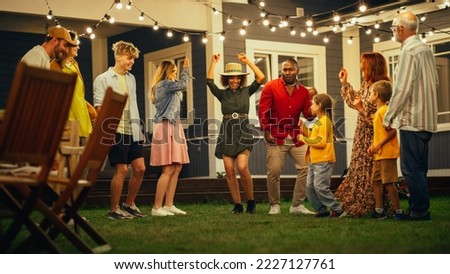Parents, Children and Multicultural Friends Dancing Together at a Garden Party Disco Event at Home. Young and Senior People Relaxing, Having Fun on a Summer Evening. Slow Motion Footage.