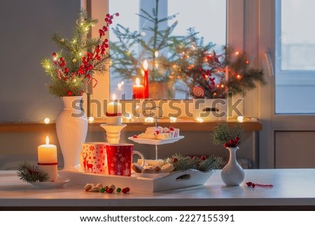 christmas decor and red cups with hot drink on kitchen