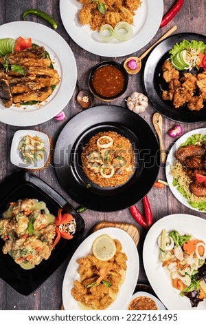 
a photo of a collection of typical Indonesian food taken from above. suitable for restaurant menu book background. Taken in July 2022 at a restaurant in Indonesia.
