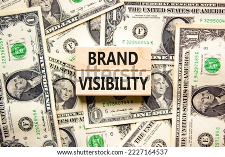 Brand visibility symbol. Concept words Brand visibility on wooden blocks. Beautiful background from dollar bills. Business branding and brand visibility concept. Copy space.