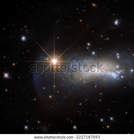 Telescope image captures a galaxy and a star named Lacerta Star. Twinkling stars in outer space. The elements of this image furnished by NASA. Royalty-Free Stock Photo #2227187093