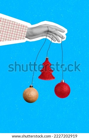Vertical collage picture of human arm black white colors fingers hold hanging newyear tree bauble toys isolated on blue background