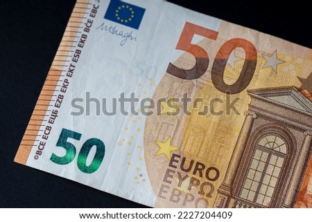 50 euro banknote close up on black background for business finance topics. World money concept, inflation and economy concept. Currency close up in detail.