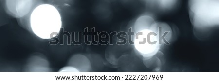 Blurred lights, gray, deep blue background, banner texture. Abstract bokeh with soft light header. Wide screen wallpaper. Panoramic web banner with copy space for design