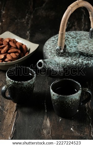 Teapot and cup with dark background. Tea set so rustic. Teko dan cangkir teh