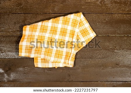 checkered napkin isolated on wood table with copy space for your product