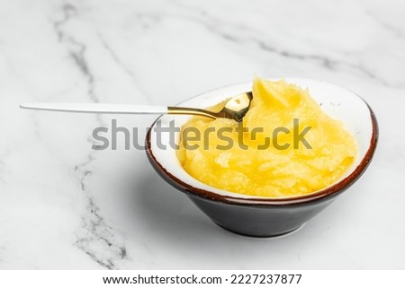 Homemade Melted ghee clarified butter. Bio Ayurveda Lactose free high quality butter on a light background. place for text, top view. Royalty-Free Stock Photo #2227237877