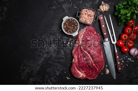 Raw veal meat, beef steak on black background, Whole piece of steaks ready to cook. banner, menu, recipe place for text, top view. Royalty-Free Stock Photo #2227237945