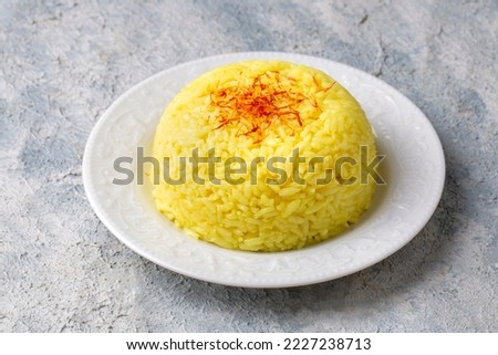 A plate of saffron rice pilaf (Turkish name; safranli pilav) Royalty-Free Stock Photo #2227238713