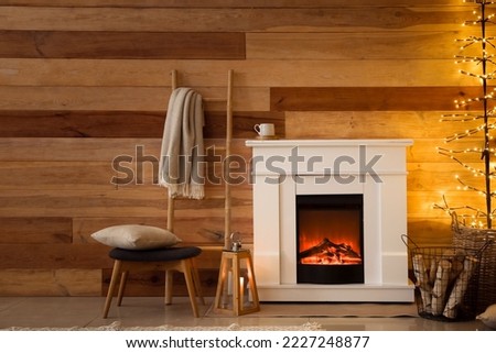 Interior of living room with fireplace and glowing tree lamp