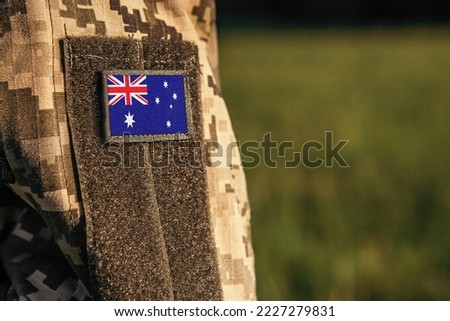 Close up millitary woman or man shoulder arm sleeve with Australia flag patch. Australia troops army, soldier camouflage uniform. Armed Forces, empty copy space for text

