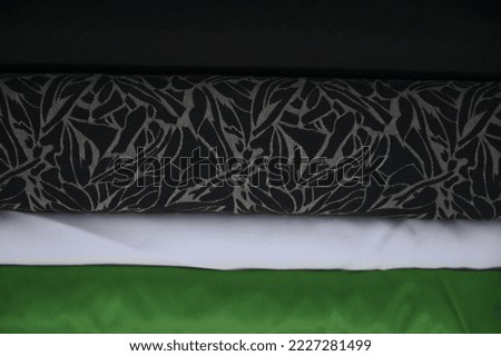 Green, white, textured and black fabric