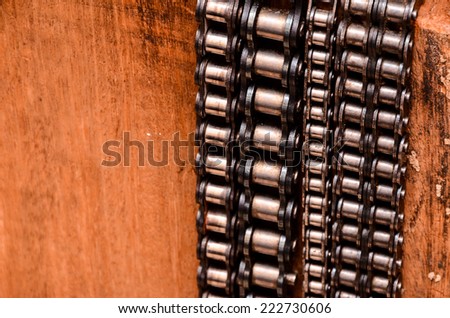 Part of a Used Automotive Gear Chain n a Wooden Background
