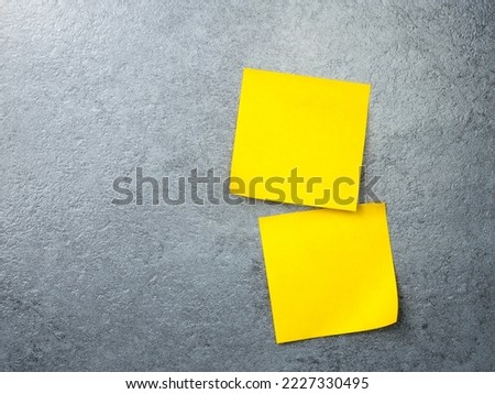 Blank yellow sticky note on texture background. Paper note on wall. to add text copy space.