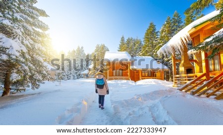 View of winter season with wooden chalets in snowy forest. Snowy winter landscape during christmas holidays. Sunny snow landscape in winter season. christmas scenery for winter holidays in europe.