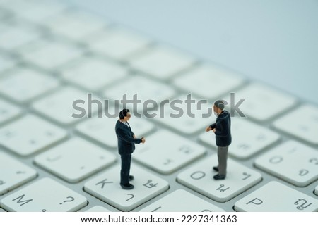 Miniature businees man  stand on a keyboard , thai launguage keyboard