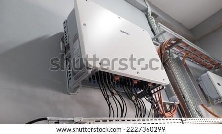 Instalation control of  inverters solar panel on the wall.Technology of solar energy. Royalty-Free Stock Photo #2227360299