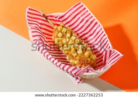 Delicious Crunchy Korean Style Chunky Potato Corn Dogs with Batter and Cubed Fried Potatoes.  Royalty-Free Stock Photo #2227362253
