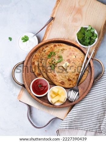 Aloo paratha or gobi paratha also known as Potato or Cauliflower stuffed flatbread dish originating from the Indian subcontinent. Royalty-Free Stock Photo #2227390439
