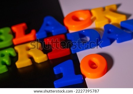 Plastic letters and the inscription Black Friday and 10 Discounts are placed on a black and white background.