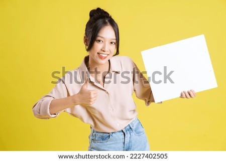 image of a pretty asian girl holding a white billboard