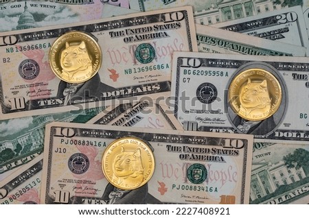 Funny - Dogecoin (DOGE) cryptocurrency pictured as a gold coin lying over dollars, real US money, 50 dollars, United States fifty-dollar bill