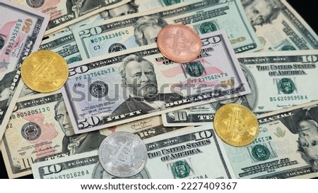 Bitcoin cash (BTC), cryptocurrency pictured as a gold, silver, rose gold coins lying over dollars, real US money, 50 dollars, United States fifty-dollar bill