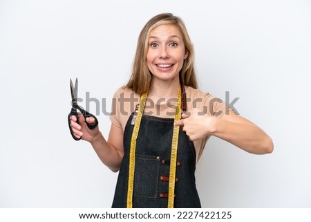 Young blonde seamstress woman isolated on white background with surprise facial expression