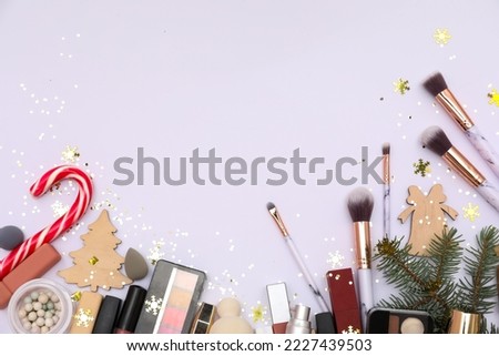 Frame made of makeup products and Christmas decor on white background